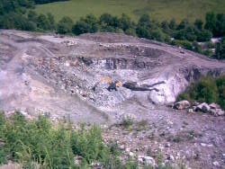 Lone worker breaking limestone rocks. 13 June 2009